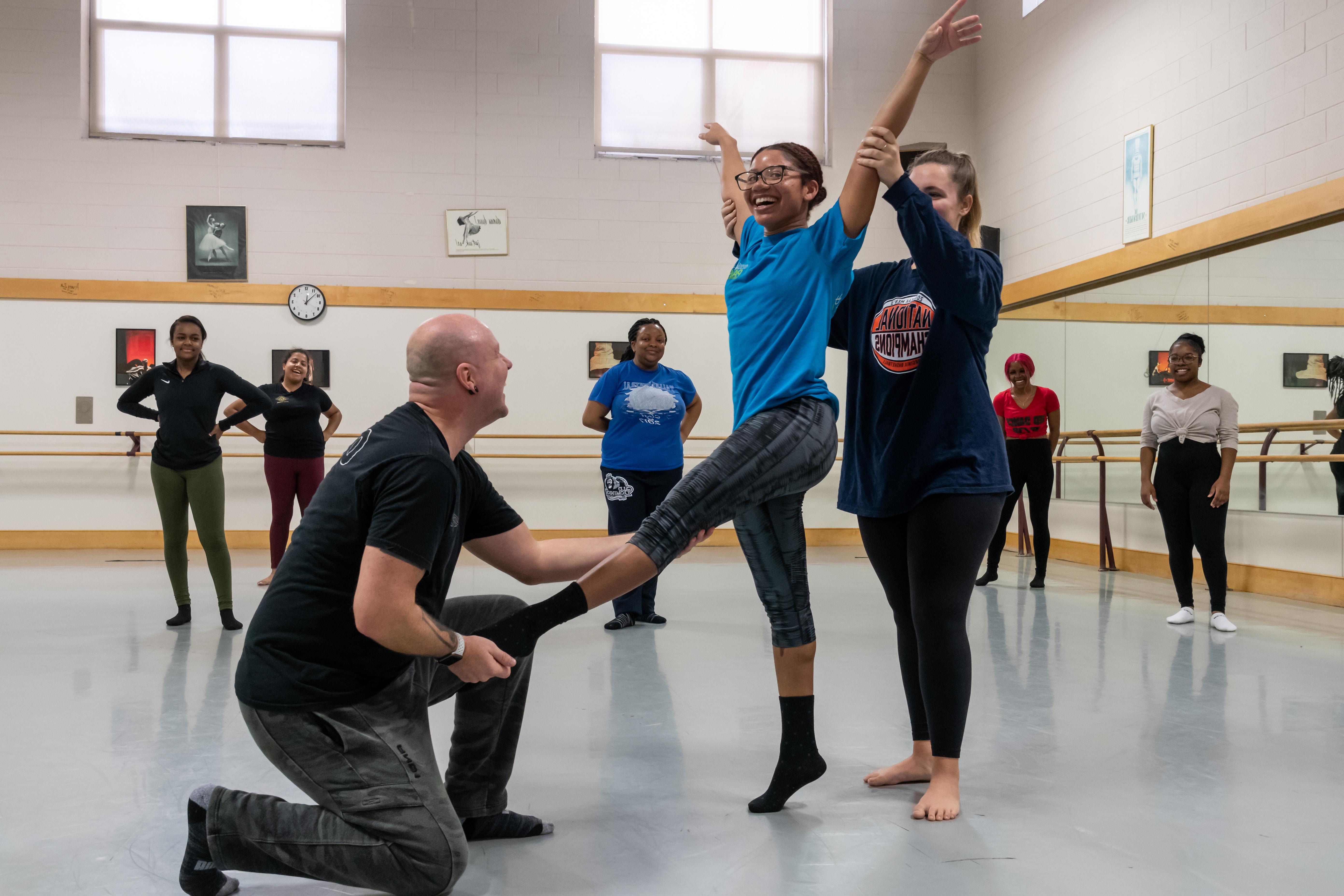 Instructor assists dance student at Pre-Collegiate Summer Dance Intensive.