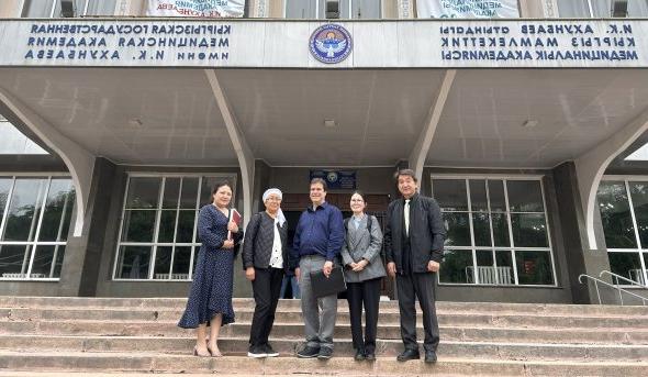 Photo of a group of people standing in front of a building.