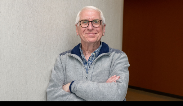 Bill Owings stands in a hallway in the Education Building.