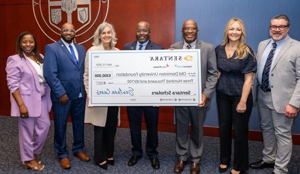 ODU and Sentara Healthcare representatives pose with a large bank check for $300,000 made out to the Old Dominion University Foundation.