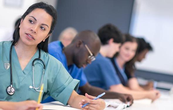 Certified Medical Assistant at desk