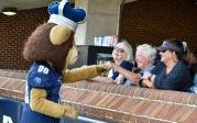 Ann Raymond-Savage fist-bumps Big Blue before the football game. Photo Chuck Thomas/ODU